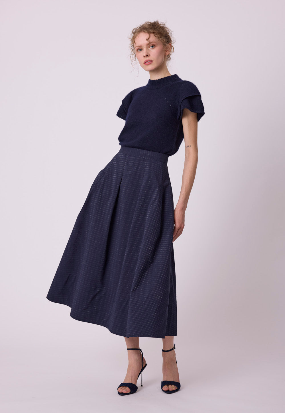 Detail of the Antonia Zander Maika Top, highlighting delicate openwork knitting and layered ruffle sleeve construction.