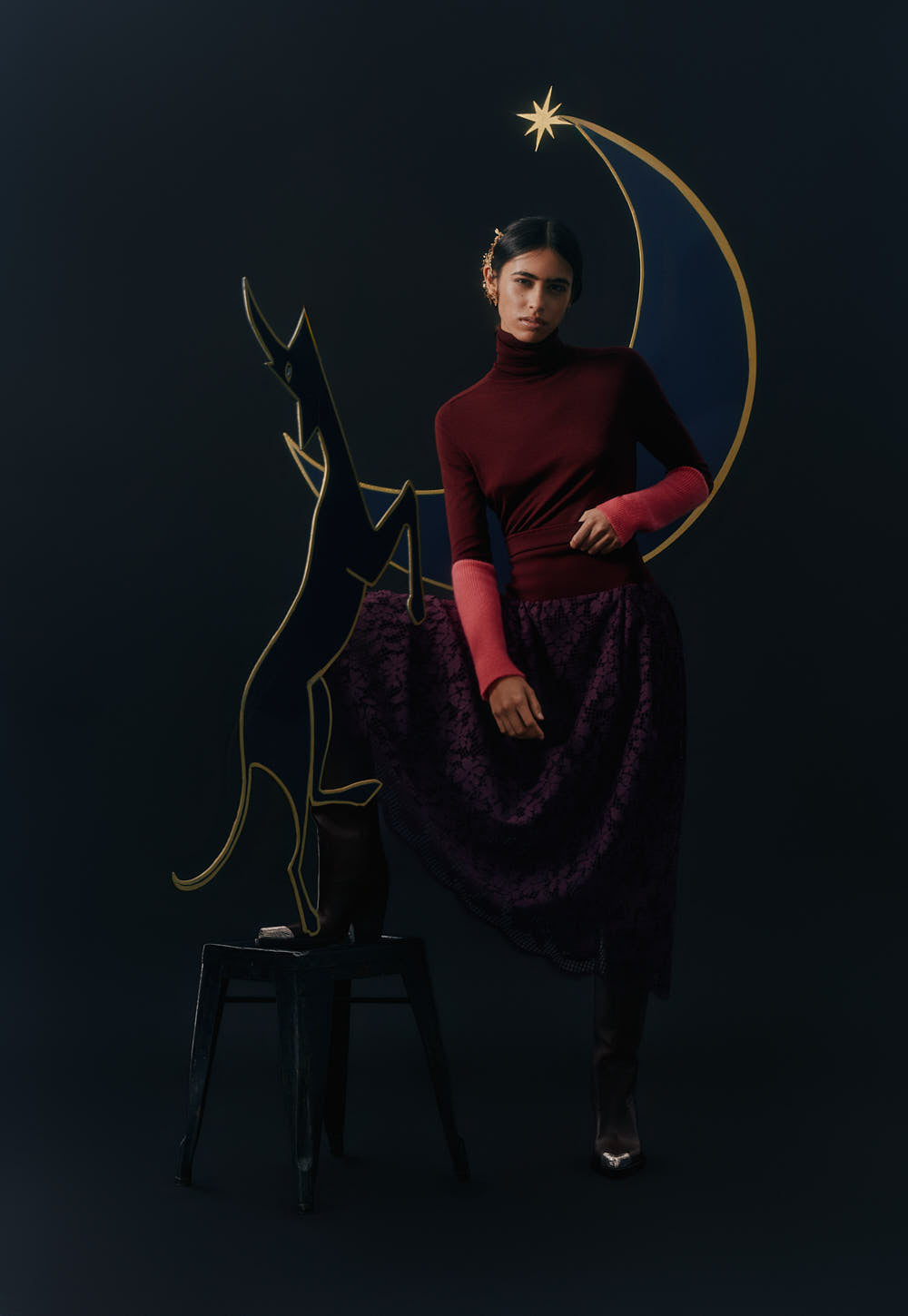 Slim turtleneck sweater with elongated sleeves, styled in motion, elegant editorial scene