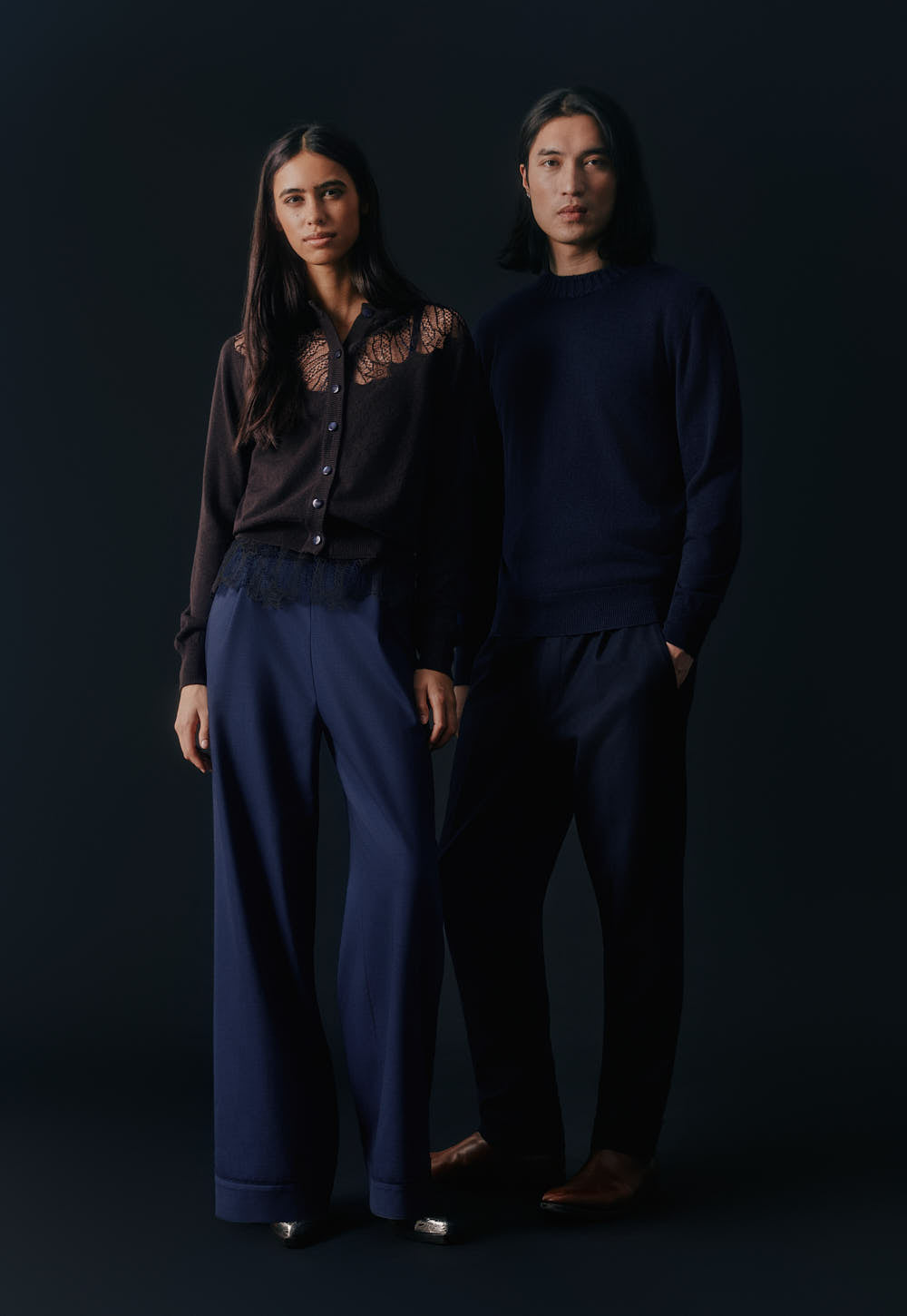 Model wearing the Antonia Zander Peppa Cardigan crafted from finest Italian cashmere with delicate lace inserts, styled with navy tailored Raya pantsuit.
