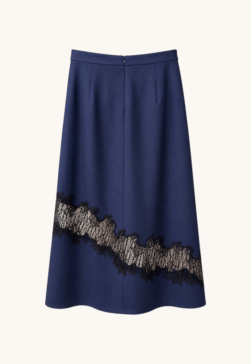 Back view of the Antonia Zander Romina Skirt in navy with concealed back zip closure and asymmetrical lace detail.